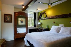 1 dormitorio con 1 cama grande y espejo en Boutique Hotel Bonjour en Gronsveld