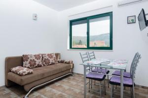 una sala de estar con un sofá y una mesa en Apartments Leo, en Orebić