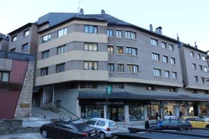 a large building with cars parked in front of it at Vielha III in Vielha