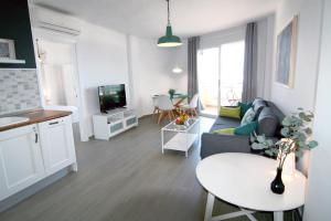 a living room with a couch and a table at Duquesa de España in Torremolinos