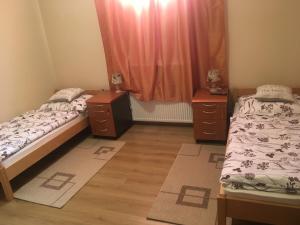 a bedroom with two beds and two night stands at Apartman Sveti Rok in Zagreb