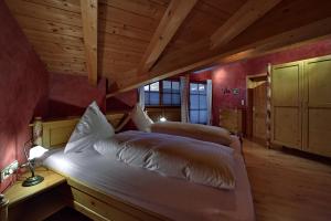 a bedroom with a bed in a room with wooden ceilings at Landhaus Bauer in Oberstdorf +112 photos