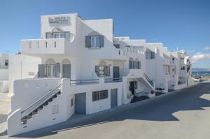 a white building with a lot of windows at Pension Elena in Agia Anna Naxos