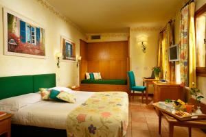 a hotel room with a bed and a desk at Hotel Santa Maria in Rome