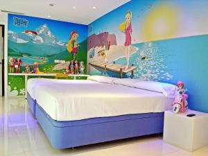 a bedroom with a disney mural on the wall at Hotel del Juguete in Ibi