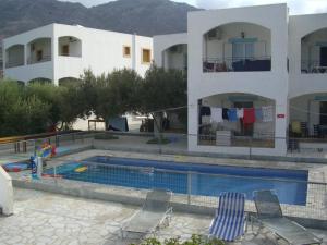 a swimming pool in front of a house at Climbing House Annas Apartments in Panormos Kalymnos
