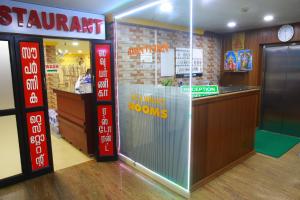 a fast food restaurant with a counter with a sign on it at Avanti Inn in Guruvāyūr