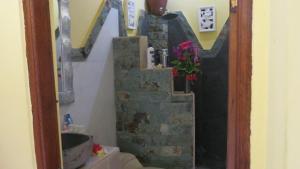 a bathroom with a stone staircase with a flower pot at Pt putra momongan menyelam scuba in Amed