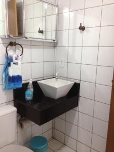 a bathroom with a sink and a mirror at Flat em Sao Jose da Coroa Grande in São José da Coroa Grande