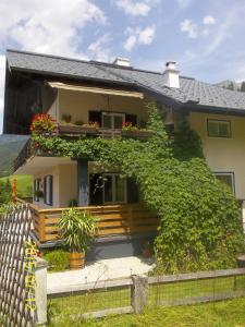 a house with ivy growing up the side of it at Haus Wastl in Russbach am Pass Gschütt