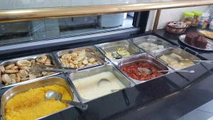 a buffet line with many different types of food at Hotel Uzi Mar in Recife