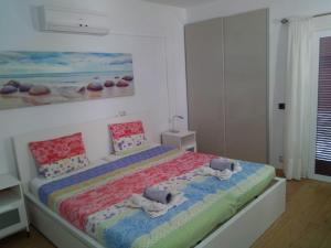 a bedroom with a bed with towels on it at Beach Suite Playa Cala dor in Cala d´Or