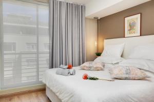 a bedroom with a bed with two stuffed animals on it at The Odyssee 409 in Cape Town +30 photos