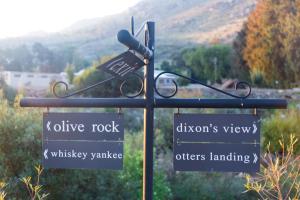 a street sign with directional signs on a pole at White Bridge Farm Accommodation in Wolseley +2 photos