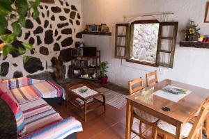 a living room with a couch and a table at La Cuadra in Hermigua