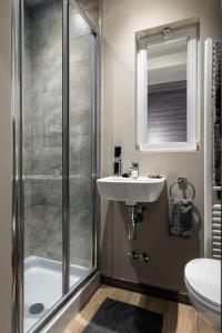 a bathroom with a shower and a sink at Leonardo Duplex Apartment in Milan