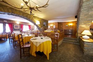 a restaurant with tables, chairs, and tables in it at Hotel Dolonne in Courmayeur