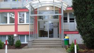a building with a revolving door in front of it at Hostel Fortis in Ostrołęka