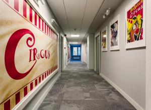 a long hallway with a cocacola sign on the wall at B&B Julinek Park in Leszno