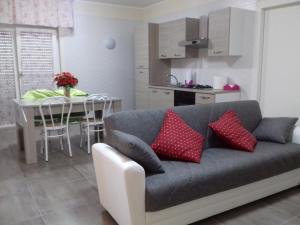 a living room with a couch and a table and a kitchen at Palazzo del Mare in Naples