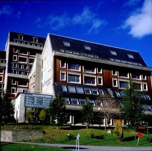 a large building with a lot of windows on it at Multipropiedad Baqueira 1500 in Baqueira-Beret