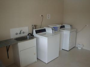 a kitchen with two washers and a sink in a room at Kentish Hills Retreat in Sheffield