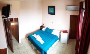Postel nebo postele na pokoji v ubytování Hostal La Posada De Jose Carlos
