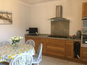 a kitchen with a table and a stove top oven at Seascape in Cleethorpes