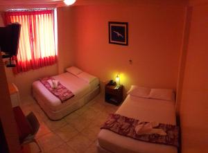 Postel nebo postele na pokoji v ubytování Hostal La Posada De Jose Carlos