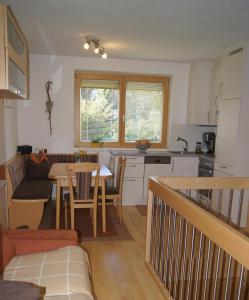 a kitchen and living room with a table and a couch at Haus Rainer in Innsbruck