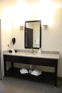 a bathroom with two sinks and a mirror at Sleep Inn & Suites Galion in Galion