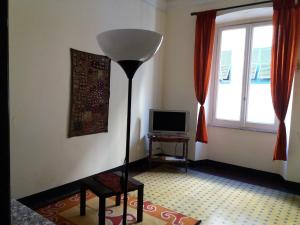 a living room with a floor lamp and a television at Residenza dell'Orto in Chiavari