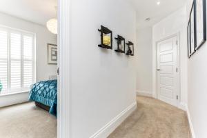 a bedroom with a bed and a door with a mirror at 3, Gainsborough House in Cheltenham