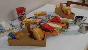 a table with two plates of hot dogs and snacks at Hotel Ferreira Viana in Rio de Janeiro