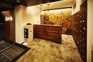 a bathroom with a large tub and a large painting on the wall at Guest House Wagokoro in Tokyo