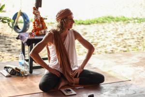 a woman sitting on the floor in front of a table at Drishti yoga international in Patnem