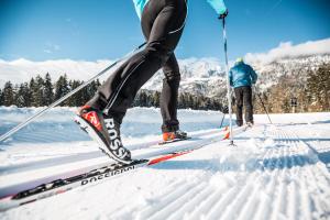 two people are cross country skiing in the snow at Appartement Lindner Hannes in Westendorf