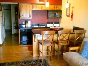 a kitchen with a counter and a bar with stools at River Run Retreat in New Braunfels