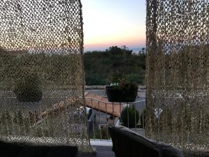 a view of a patio with a wall of glass at Residenza RoMa in Tropea
