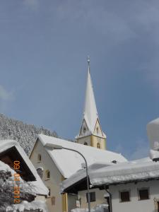 カップルにあるHaus Alblittの雪に覆われた険しい教会