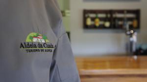 a person wearing a shirt with an alica bar college logo at Aldeia da Cuada in Faja Grande