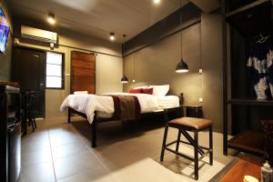 a bedroom with a bed and a table and chairs at Duangdren Place in Chiang Mai