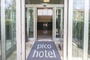 una porta scorrevole in vetro con un cartello dell'hotel per la pizza; di Hotel Pico a Mirandola
