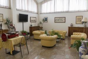 a large living room with couches and a tv at Hotel Pico in Mirandola