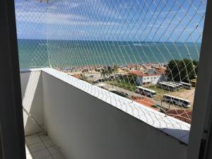 a view of the ocean from a balcony with a net at Flat em Sao Jose da Coroa Grande in São José da Coroa Grande