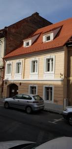 a house with a silver car parked in front of it at Casa Fanarilor in Braşov