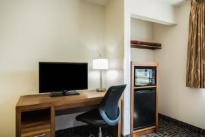 a room with a desk, chair and a television at Super 8 by Wyndham Flagstaff in Flagstaff