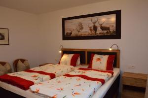 a bedroom with two beds and a picture of deer at Ferienwohnung Haas Maria in Neustift im Stubaital