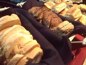 a bunch of different types of bread on a table at Bohemia Hotel Boutique in Mendoza