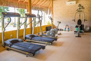 a gym with several tread machines in a room at Villa dos Corais in Morro de São Paulo